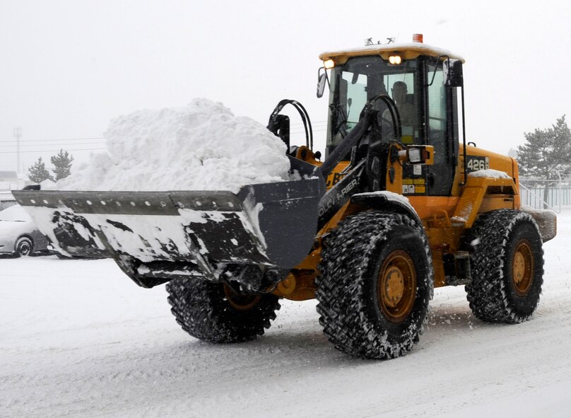 The 35th Civil Engineer Squadron snow removal team clears large amounts of snow from the collocated club parking lot Dec. 27, 2012, at Misawa Air Base, Japan. Since November, 35 CES personnel began working 24-hour operations to ensure winter weather doesn’t stop the 35th Fighter Wing’s mission. (U.S. Air Force photo by Airman 1st Class Kaleb Snay)