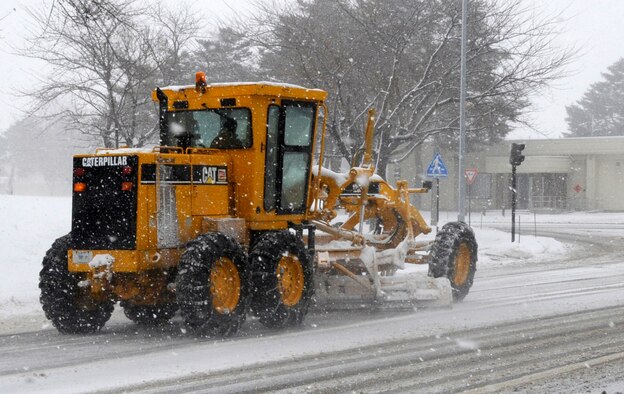 Members of the 35th Civil Engineer Squadron snow removal team plow roads after an eight inch snowfall struck Dec. 27, 2012, at Misawa Air Base, Japan. The team’s mission is to clear the base’s priority roads of snow before moving on to parking lots and secondary roadways. (U.S. Air Force photo/Airman 1st Class Kaleb Snay) 