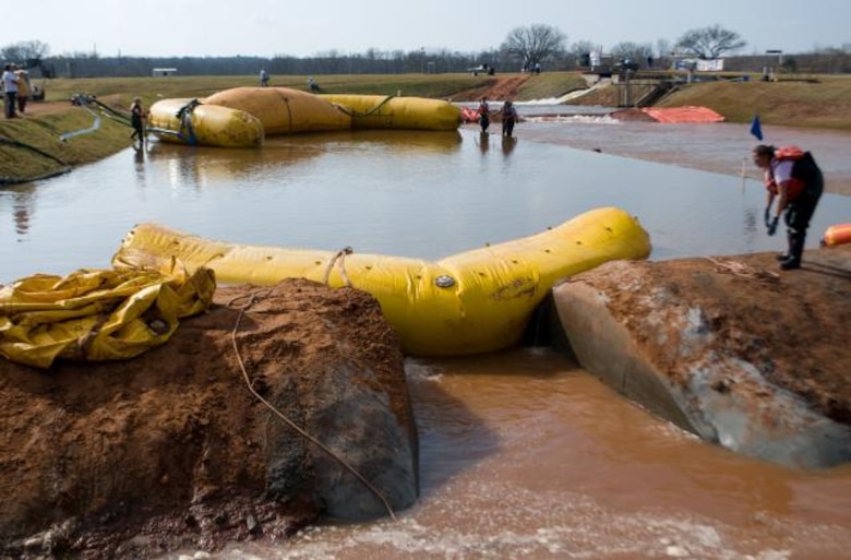 CHL researchers supervise deployment of the PLUG during a test levee breach exercise.