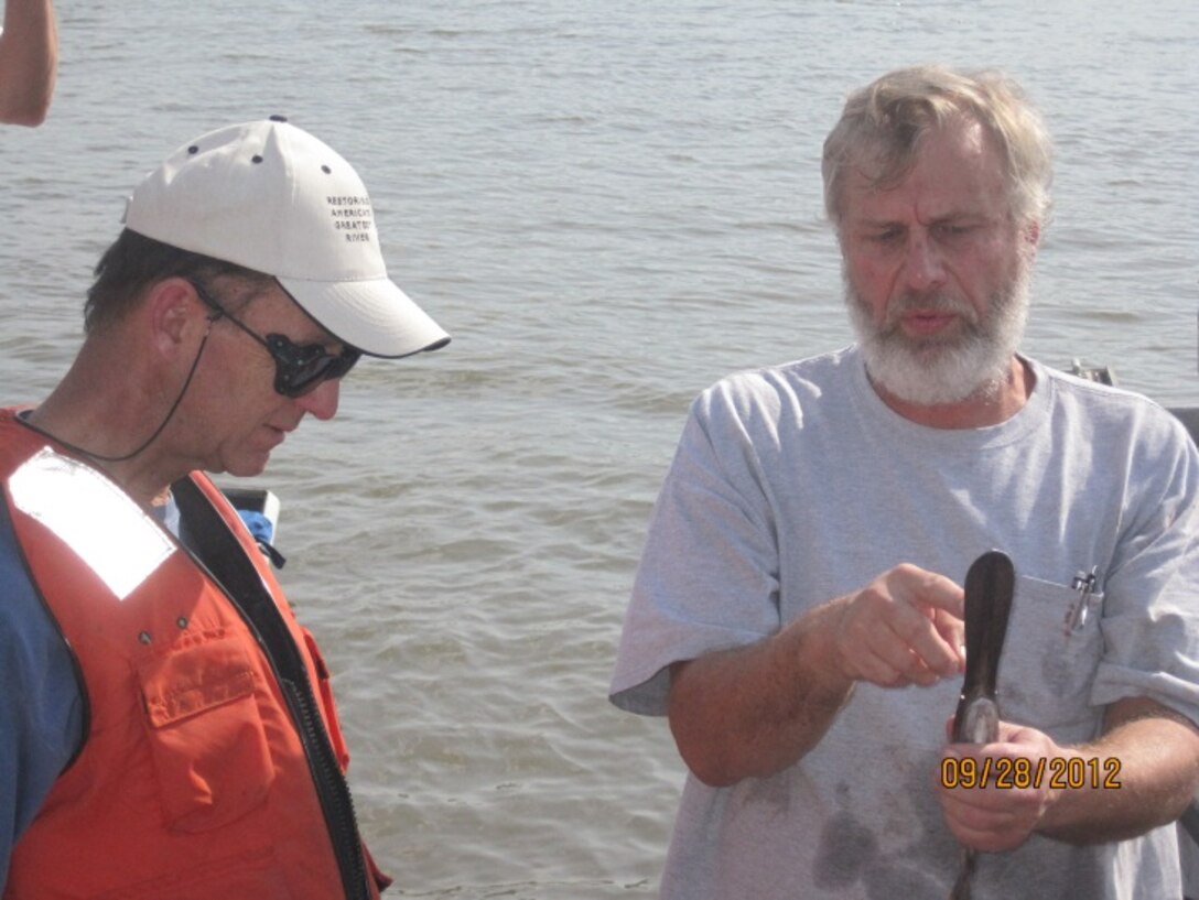 ERDC Environmental Laboratory Research Fisheries Biologist Dr. Jan Hoover (right), shows Conservationist Theodore Roosevelt IV, a paddlefish. (Photo by Jack Killgore, ERDC-EL)
