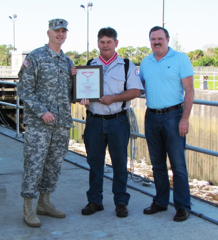 Lt. Col. Thomas Greco presented St. Lucie Lock Leader Michael L. Carter (center) with the Steel de Fleury Medal Dec. 19 at the St. Lucie Lock in Stuart, Fla. Also present was South Florida Operations Office Chief, Steve Dunham (right).