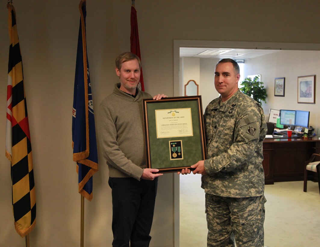 Lt. Col. Brad Endres, acting Baltimore District commander, presents the Army Commendation Award to Eric Barbour, health physicist. Barbour was recognized for his work in support of three projects associated with the termination of the Walter Reed Army Medical Center U.S. Nuclear Regulatory Commission license.