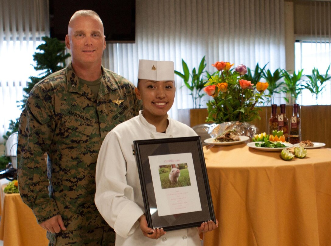 MARINE CORPS BASE HAWAII - Col. Brian P. Annichiarico, base commander, Marine Corps Base Hawaii, stands with 2012 Chef of the Year winner Cpl. Blanquivett Robinson, food service administration clerk, Anderson Hall Dining Facility, at the dining facility, Dec. 19. “I’m glad I wasn’t a judge because there were so many different tastes and they were all good,” Annichiarico said. “The chefs outdid themselves and I like seeing this healthy competition.” (Official U.S. Marine Corps photo by Cpl. Vanessa American Horse)