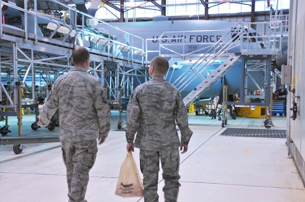 Chaplain (Capt.) Roland Reitz spent time with Alaska Air National Guardsmen and active duty members at Hangar 18 on Joint Base Elmendorf-Richardson Dec. 19.  JBER Air Force and Air Guard chaplains visited flight line workers Dec. 17-19 to hand out candy canes and good cheer. National Guard photo by Staff Sgt. N. Alicia Goldberger.