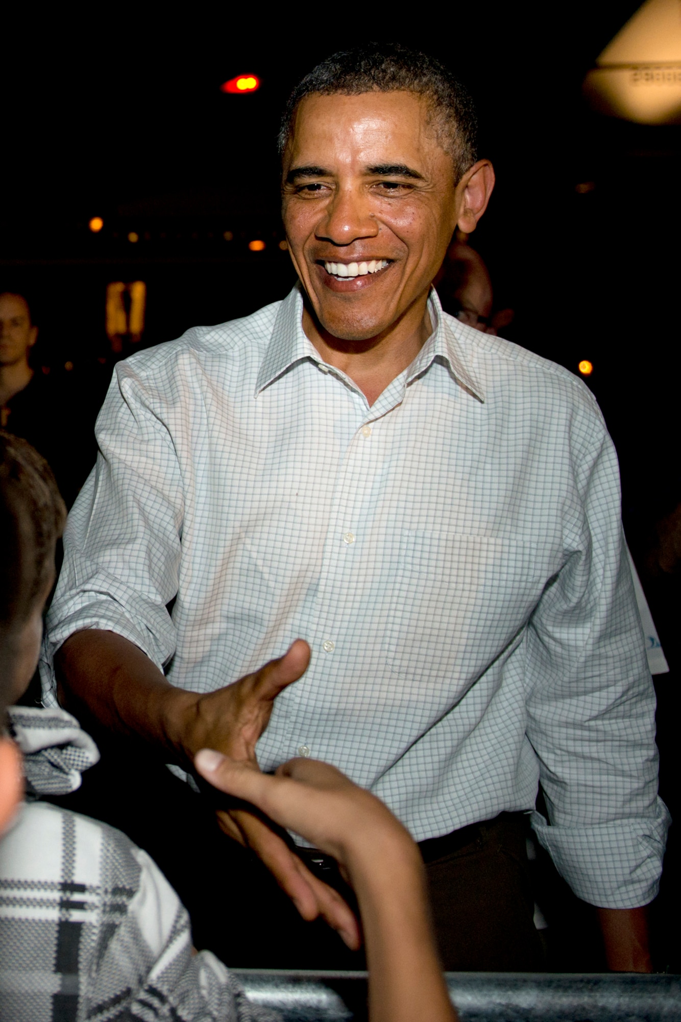 President Barack Obama shakes hands with servicemembers and families at Hickam Field, Joint Base Pearl Harbor-Hickam, Hawaii, before boarding Air Force One, Dec. 26, 2012. After a brief vacation in Hawaii, President Obama is on his way back to Washington to address proposed extended tax cuts and looming fiscal cliff. (U.S. Air Force photo/Staff Sgt. Mike Meares)