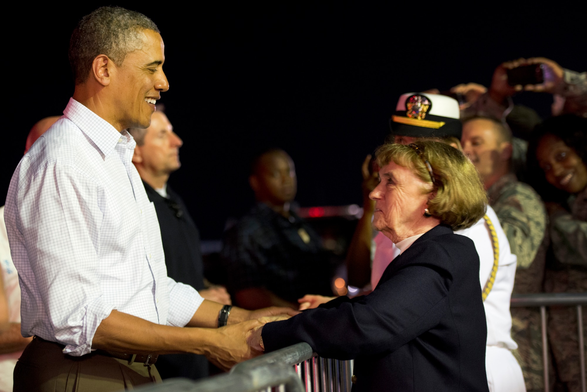 President Barack Obama greets Sharon McPhee, of Honolulu, before his deaprture from Hickam Field, Joint Base Pearl Harbor-Hickam, Hawaii, Dec. 26, 2012. The president shook hands with servicemembers and families before boarding Air Force One. After a brief vacation in Hawaii, Obama is on his way back to Washington to address proposed extended tax cuts and a looming fiscal cliff. McPhee's late husband, Dr. Roderick McPhee, was the president of Punahou High School, and his signature is on Obama's High School diploma. (U.S. Air Force photo/Staff Sgt. Mike Meares)