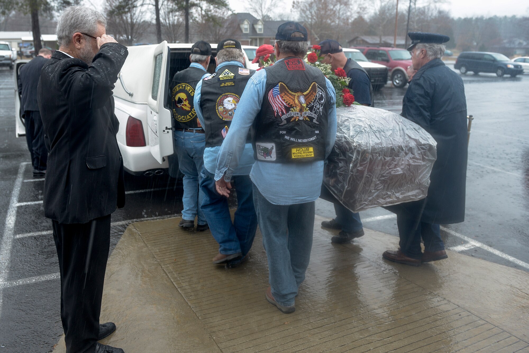 Members of the Patriot Guard Riders carry the casket of a deceased World War II veteran outside of Cedar Heights Baptist Church in North Little Rock, Ark. on Dec. 4, 2012. Funeral honors for veterans of past wars comprise the majority of Patriot Guard missions.  (U.S. Air Force photo by Staff Sgt. Russ Scalf)
