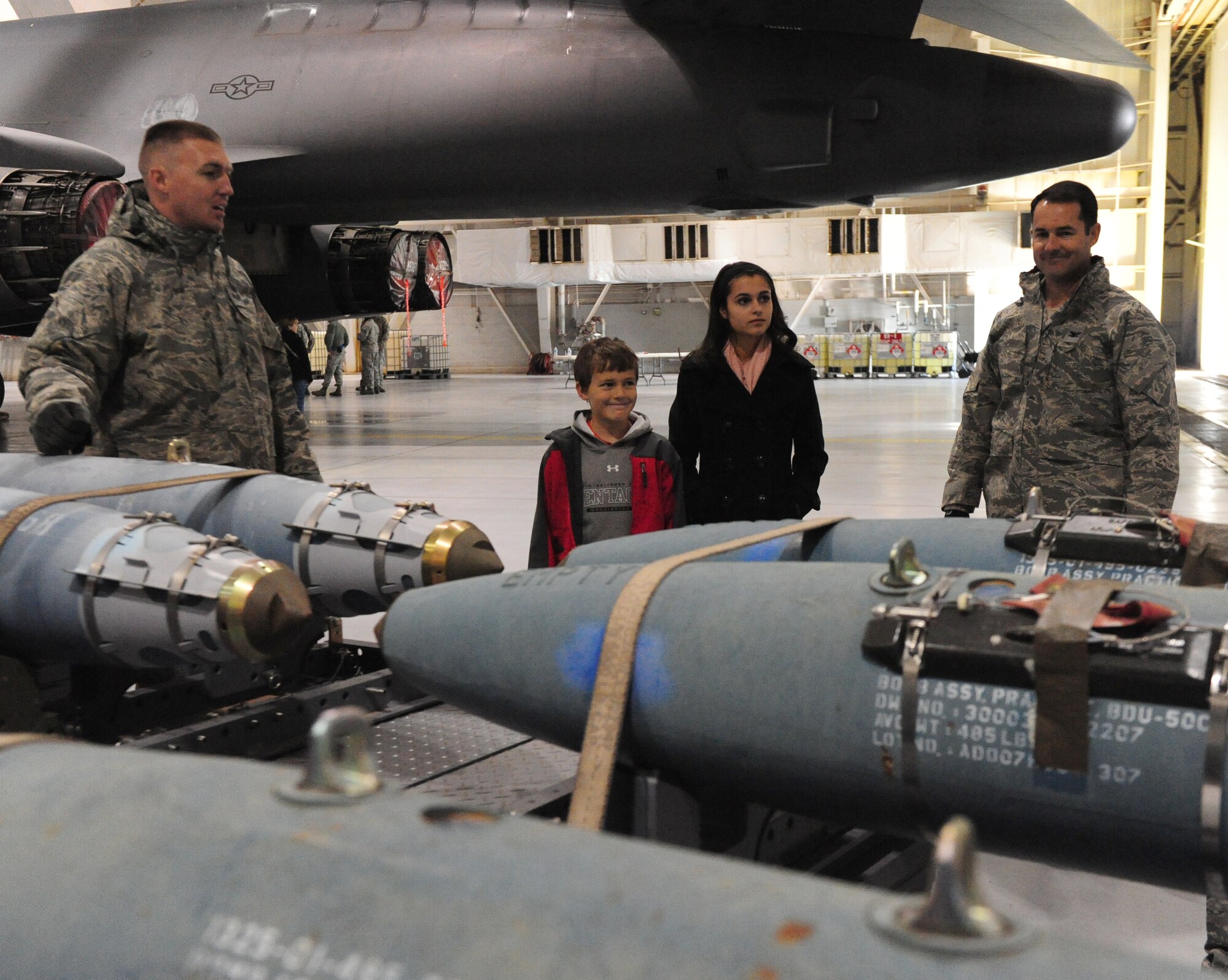Col. Vincent Lostetter, 7th Bomb Wing vice commander, and family tour static B-1 payload after signing a banner in support for the community of Sandy Hook, Conn. Dec 28, 2012. Team Dyess Airmen, employees and family members had an opportunity to tour a B-1 aircraft and sign the banner for those affected by the recent tragedy. (U.S. Air Force photo by Senior Airman Chelsea Browning/Released)
