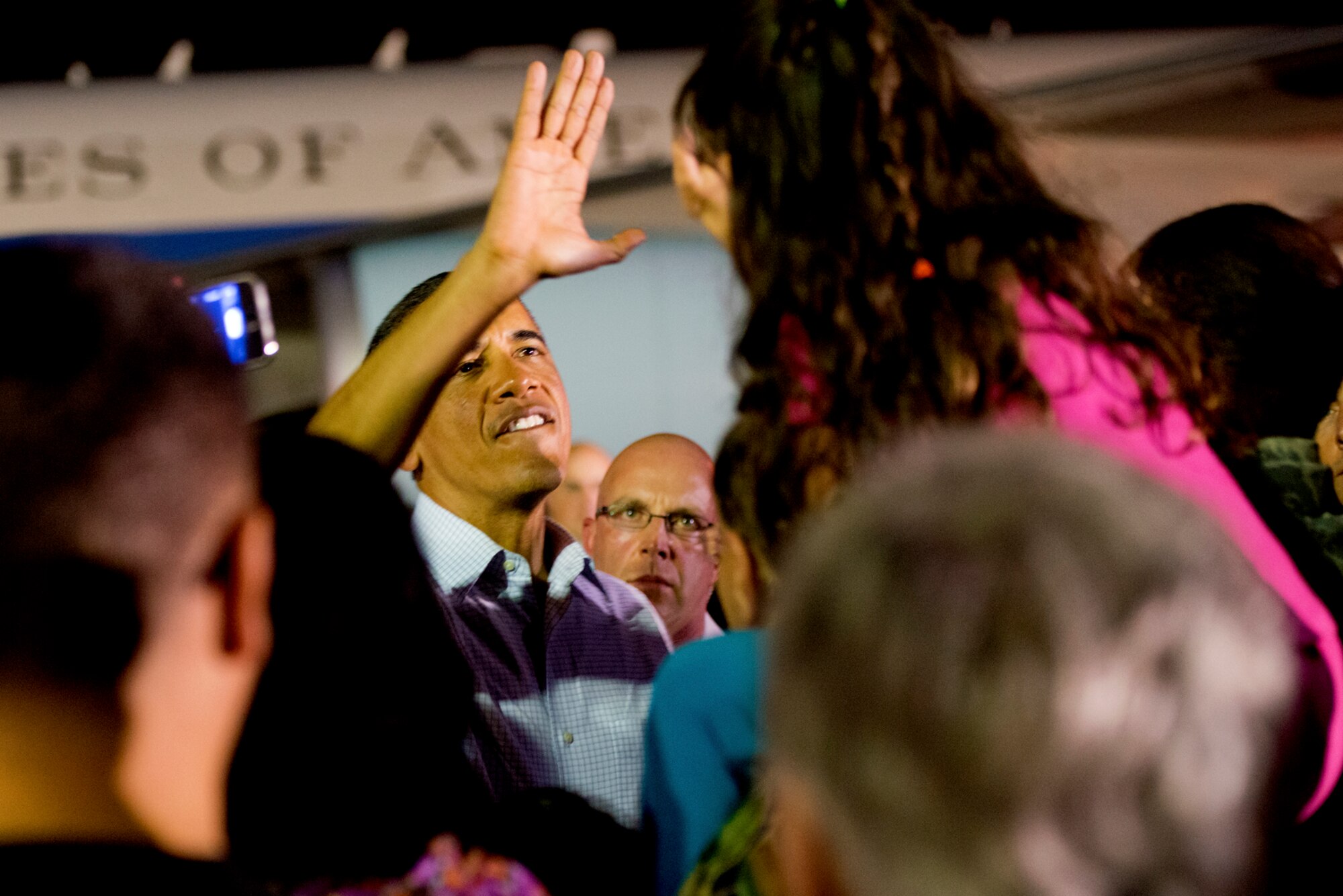 President Barack Obama high-fives Madeleine Reneau, 7, daughter of Lt. Col. Terran Reneau, Pacific Air Forces, while shaking hands with servicemembers and families at Hickam Field, Joint Base Pearl Harbor-Hickam, Hawaii, before boarding Air Force One, Dec. 26, 2012. After a brief vacation in Hawaii, President Obama is on his way back to Washington to address proposed extended tax cuts and looming fiscal cliff. (U.S. Air Force photo/Staff Sgt. Mike Meares)