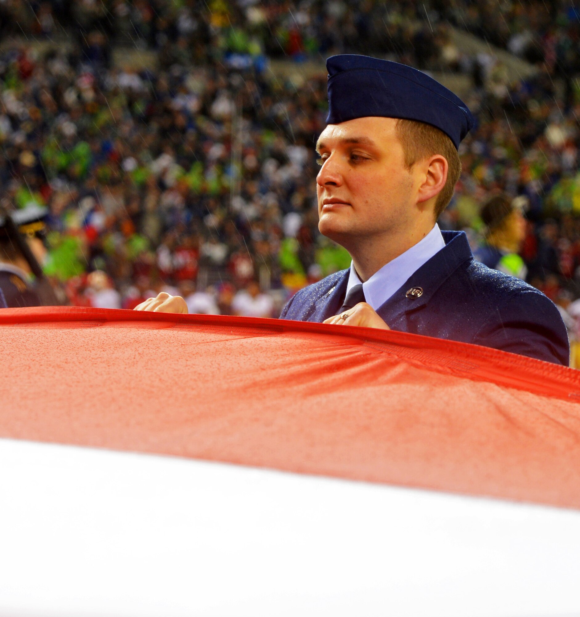 Tech. Sgt. Richard Maser, 446th Aeromedical Staging Squadron, holds the American flag during the pre-game ceremony of the Seattle Seahawks- San Francisco 49ers game in Seattle, Wash., Dec. 23. The 446th Airlift Wing, headquartered at McChord Field, had 21 Reservists on the field. (U.S. Air Force Photo/Master Sgt. Todd Wivell)