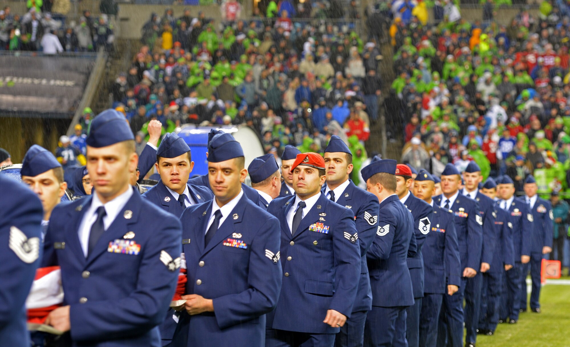 Members from the 446th Airlift Wing, along with Airmen from the 62nd Airlift Wing and Western Air Defense Sector, all headquartered at McChord Field, hold the American flag during the pre-game ceremony at the Seattle Seahawks- San Francisco 49ers National Football League game in Seattle, Wash., Dec. 23. The 446th Airlift Wing had 21 Reservists on the field. (U.S. Air Force Photo/Master Sgt. Todd Wivell)