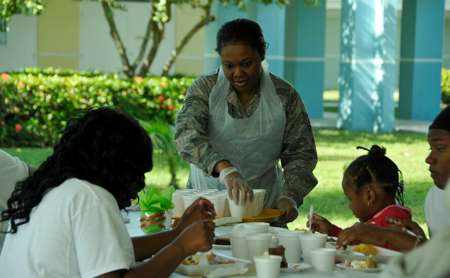 Staff Sgt. Patricia Innocent, 482nd Force Support Squadron, hands out beverages during a Christmas meal at the Chapman Partnership in Homestead, Fla., Dec. 25. Several members of Homestead Air Reserve Base, Fla., organized by the base's Unit Advisory Council, volunteered to help the Chapman Partnership, a local organization which provides comprehensive services to the homeless, during their Christmas meal. Homestead ARB has also participated with Chapman Partnership on other events such as food drives and holiday events. (U.S. Air Force photo/Senior Airman Jaimi Upthegrove)