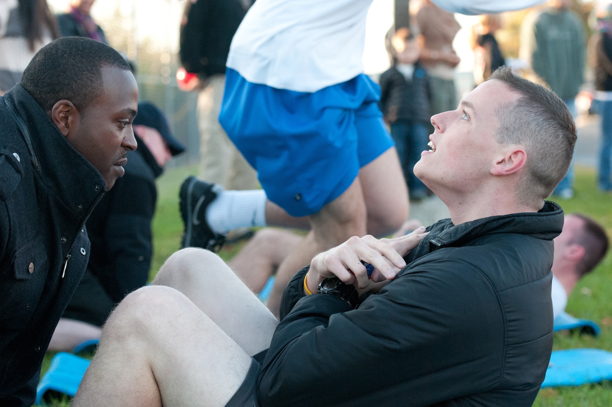 Senior Airman Elliot Lindsey, a crew chief with the 123rd Aircraft Maintenance Squadron, performs sit-ups during the 123rd Airlift Wing Fitness Challenge at the Kentucky Air National Guard Base in Louisville, Ky., on Oct. 21, 2012. The challenge tested the ability of teams from across the base to complete a timed circuit that also included 80 pushups and a 1.5-mile relay race. (U.S. Air Force photo by Senior Airman Maxwell Rechel)