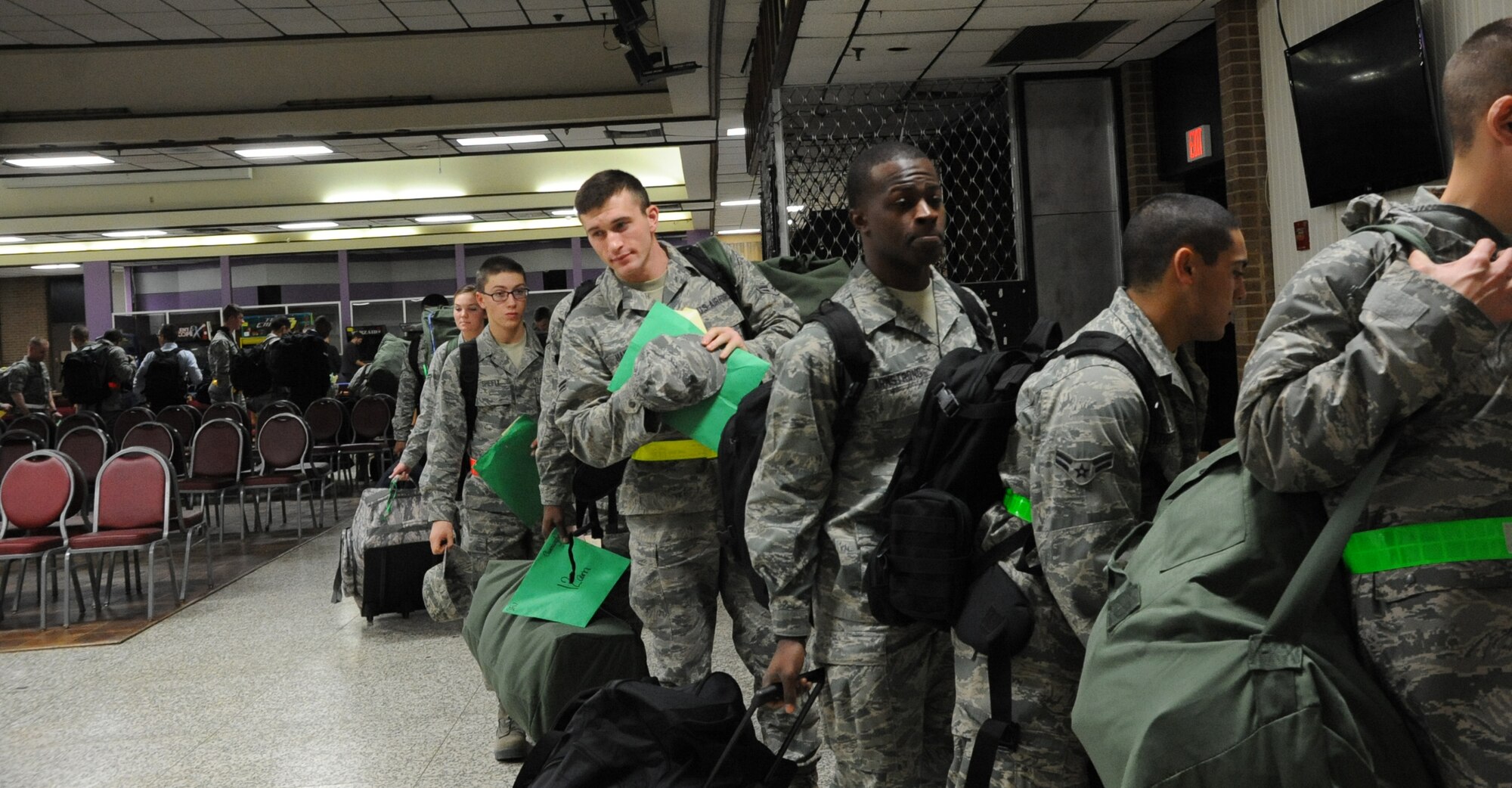 Airmen prepare to load busses leaving to Dallas, TX to catch flights home during the annual holiday exodus on Dec. 21. This year nearly 4,000 Airman went home for the holidays. (U.S. Air Force Photo/Kimberly Parker)