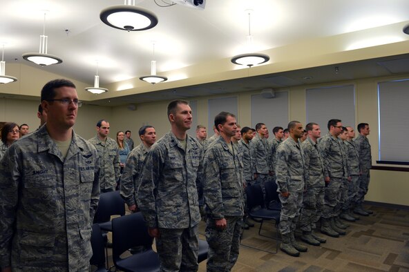 Airmen stand at attention during a Bronze Star Medal ceremony Dec. 21, 2012, at Joint Base Lewis-McChord, Wash. Staff Sgt. Andrew Cox, 5th Air Support Operations Squadron joint terminal attack controller, was awarded the Bronze Star Medal for exceptional and meritorious service while deployed May through November 2011 in Afghanistan. (U.S. Air Force photo/Staff Sgt. Jason Truskowski)
