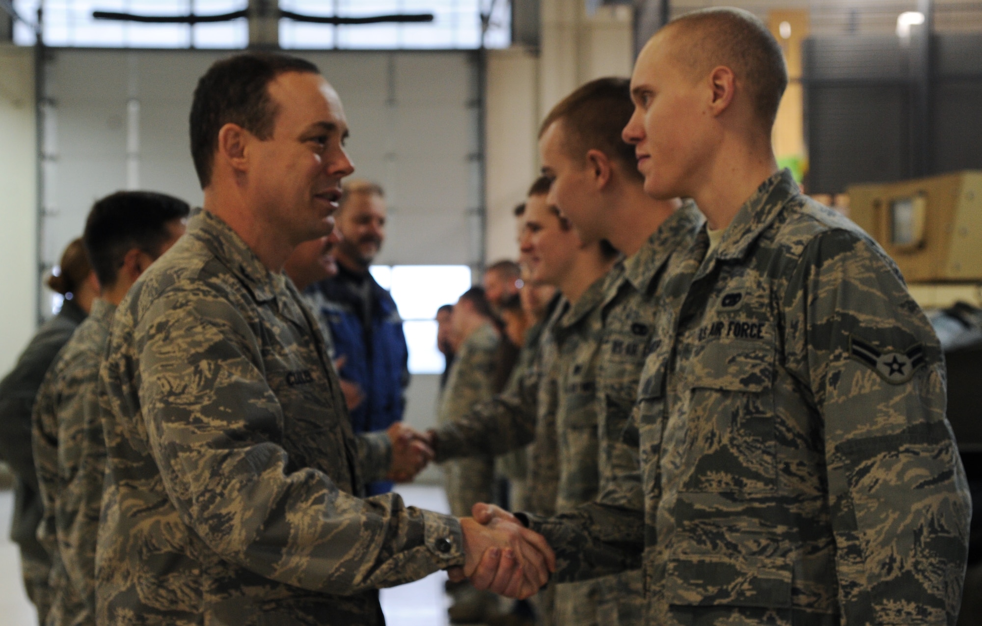 MINOT AIR FORCE BASE, N.D. -- Col. Kevin Cullen, 91st Security Forces Group commander, congratulates the team of Airmen from the 5th Logistics Readiness Squadron who were responsible for the successful stand-up of the Up-Armored vehicle fleet upgrades. The team of vehicle maintenance technicians worked on more than 40 modifications designed to improve the reliability and safety of the vehicle fleet. (U.S. Air Force photo/Senior Airman Brittany Y. Auld)