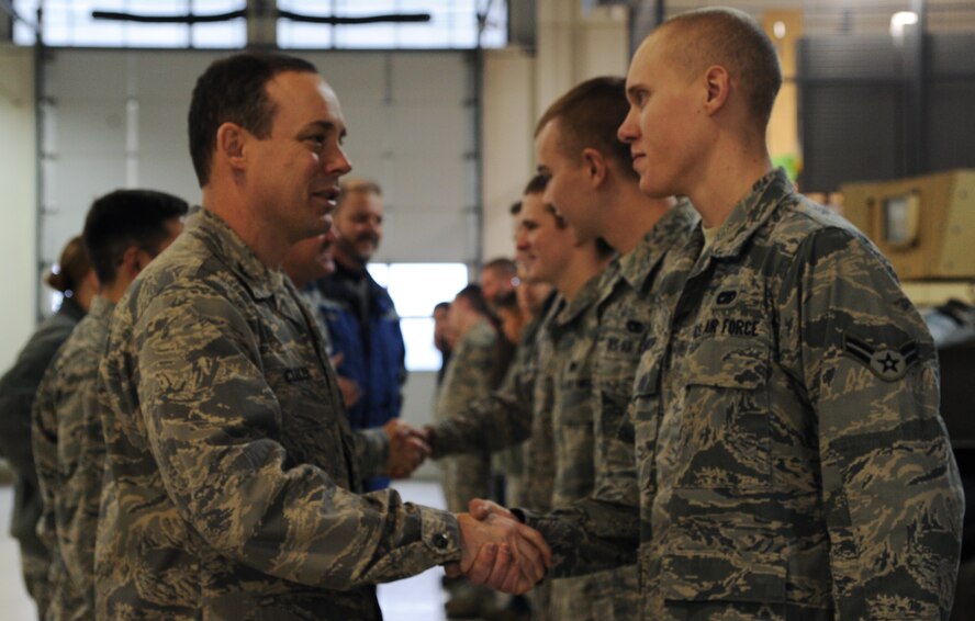 MINOT AIR FORCE BASE, N.D. -- Col. Kevin Cullen, 91st Security Forces Group commander, congratulates the team of Airmen from the 5th Logistics Readiness Squadron who were responsible for the successful stand-up of the Up-Armored vehicle fleet upgrades. The team of vehicle maintenance technicians worked on more than 40 modifications designed to improve the reliability and safety of the vehicle fleet. (U.S. Air Force photo/Senior Airman Brittany Y. Auld)
