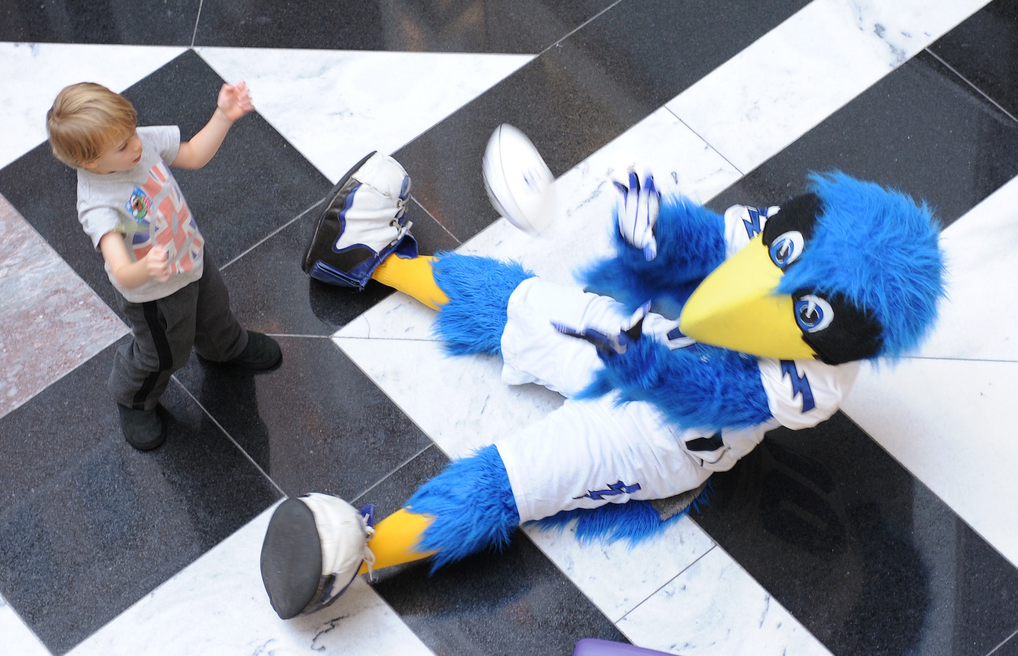 The Bird plays catch with a patient at the Cooks Children's Medical Center in Fort Worth, Texas, Dec. 27, 2012. Air Force Falcons football players and cheerleaders visited the hospital during their trip to Fort Worth to play in the Armed Forces Bowl. (U.S. Air Force photo/John Van Winkle)