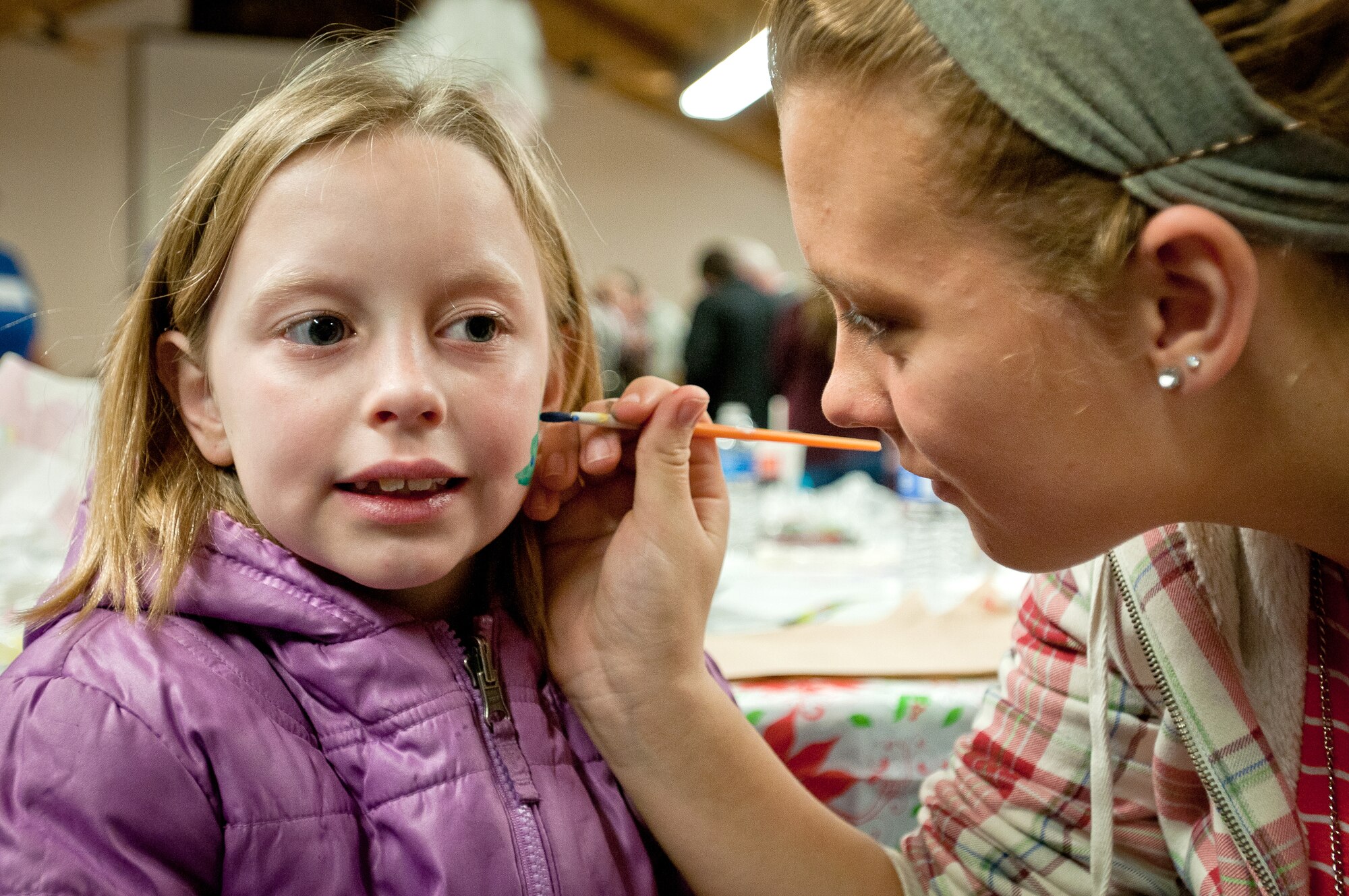 The daughter of Staff Sgt. Darrell Hinton, a structures specialist with the 123rd Civil Engineering Squadron, gets her face painted during the 123rd Airlift Wing’s family holiday party at the Kentucky Air National Guard Base in Louisville, Ky., Dec. 2, 2012. The annual event also offered snacks and prizes for the more than 85 children who participated. (Kentucky Air National Guard photo by Staff Sgt. Maxwell Rechel)