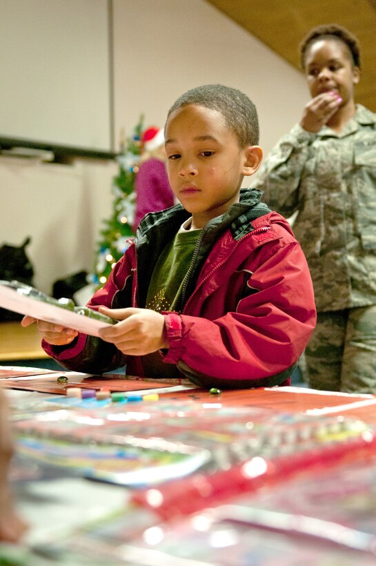 The son of Staff Sgt. Tiffany Downs, a logistics specialist with the 123rd Logistics Readiness Squadron, picks our a prize during the 123rd Airlift Wing’s family holiday party at the Kentucky Air National Guard Base in Louisville, Ky., Dec. 2, 2012. The annual event also offered snacks and face-painting for the more than 85 children who participated. (Kentucky Air National Guard photo by Staff Sgt. Maxwell Rechel)