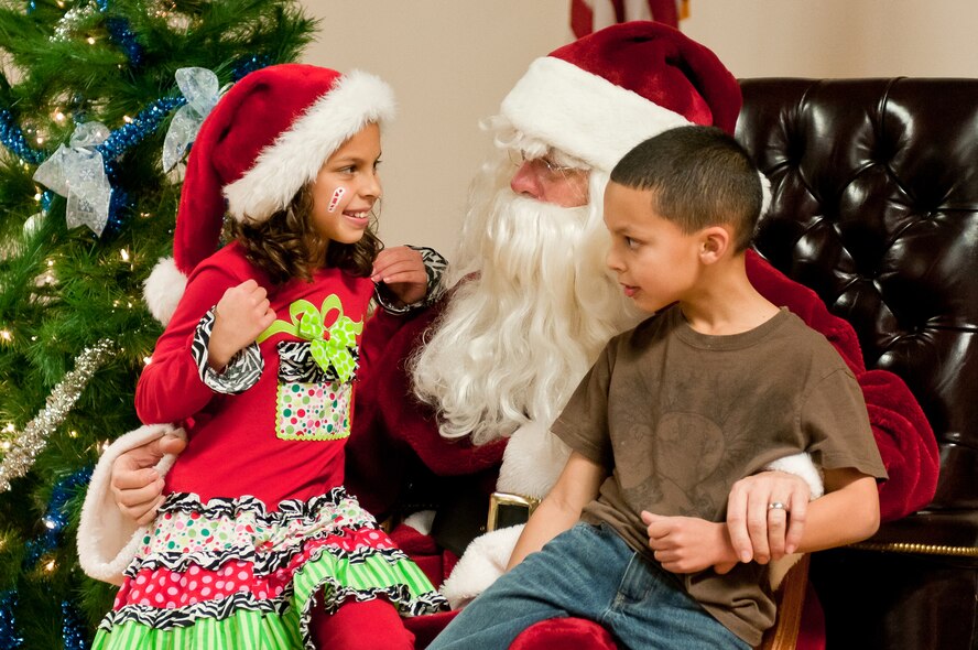 The daughter and son of Senior Airman Jose Lopez Castro, a crew chief for the 123rd Aircraft Maintenance Squadron, talk with Santa Claus during the 123rd Airlift Wing’s family holiday party at the Kentucky Air National Guard Base in Louisville, Ky., Dec. 2, 2012. The annual event also offered snacks and prizes for the more than 85 children who participated. (Kentucky Air National Guard photo by Staff Sgt. Maxwell Rechel)