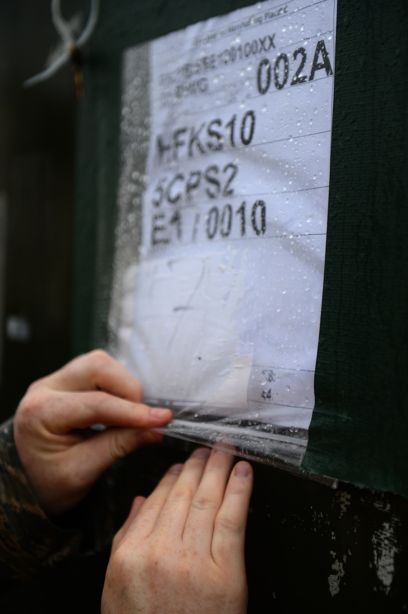 SPANGDAHLEM AIR BASE, Germany – U.S. Air Force Senior Airman Jonathan Loew, 52nd Logistics Readiness Squadron fuels hydrant from Palmer, Alaska, places paperwork inside a cargo container on the flightline Dec. 27, 2012. The cargo will accompany the 480th Fighter Squadron to Nellis Air Force Base for Red Flag, an advanced aerial combat training exercise. (U.S. Air Force photo by Airman 1st Class Gustavo Castillo/Released)