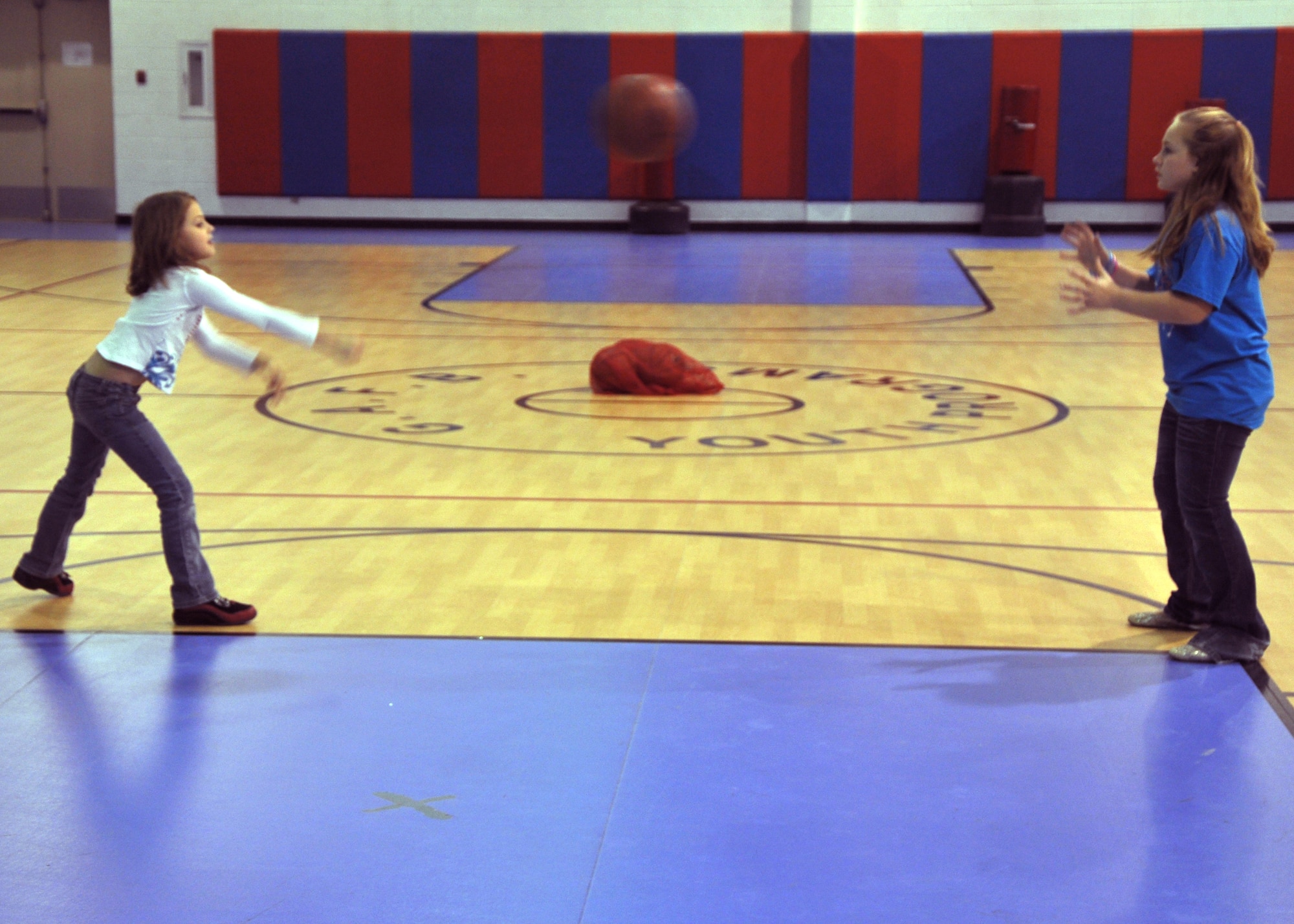GOODFELLOW AIR FORCE BASE, Texas – Fallon Dinolfo throws a basketball to Alex Kelly during the Youth Basketball Camp at the Youth Center here Dec. 26. They both did passing drills down to the halfway point of the gym. (U.S. Air Force photo/ Airman 1st Class Joshua Edwards)