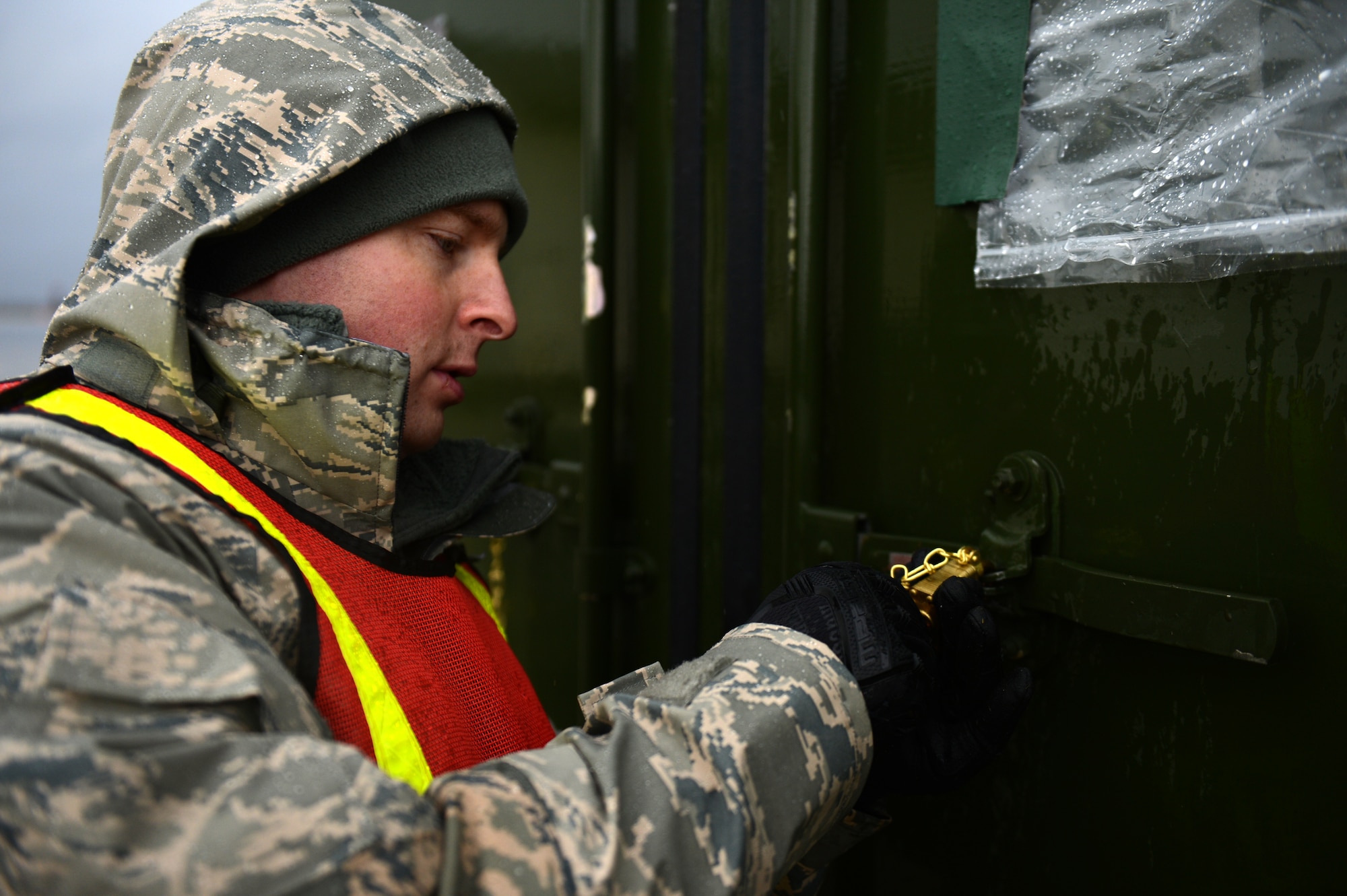 SPANGDAHLEM AIR BASE, Germany – U.S. Air Force Senior Airman Jonathan Loew, 52nd Logistics Readiness Squadron fuels hydrant  operator from Palmer, Alaska, secures a cargo container on the flightline Dec. 27, 2012. Containers must be opened and their contents verified before moving on to the next station. The cargo will accompany the 480th Fighter Squadron to Nellis Air Force Base for Red Flag, an advanced aerial combat training exercise. (U.S. Air Force photo by Airman 1st Class Gustavo Castillo/Released)