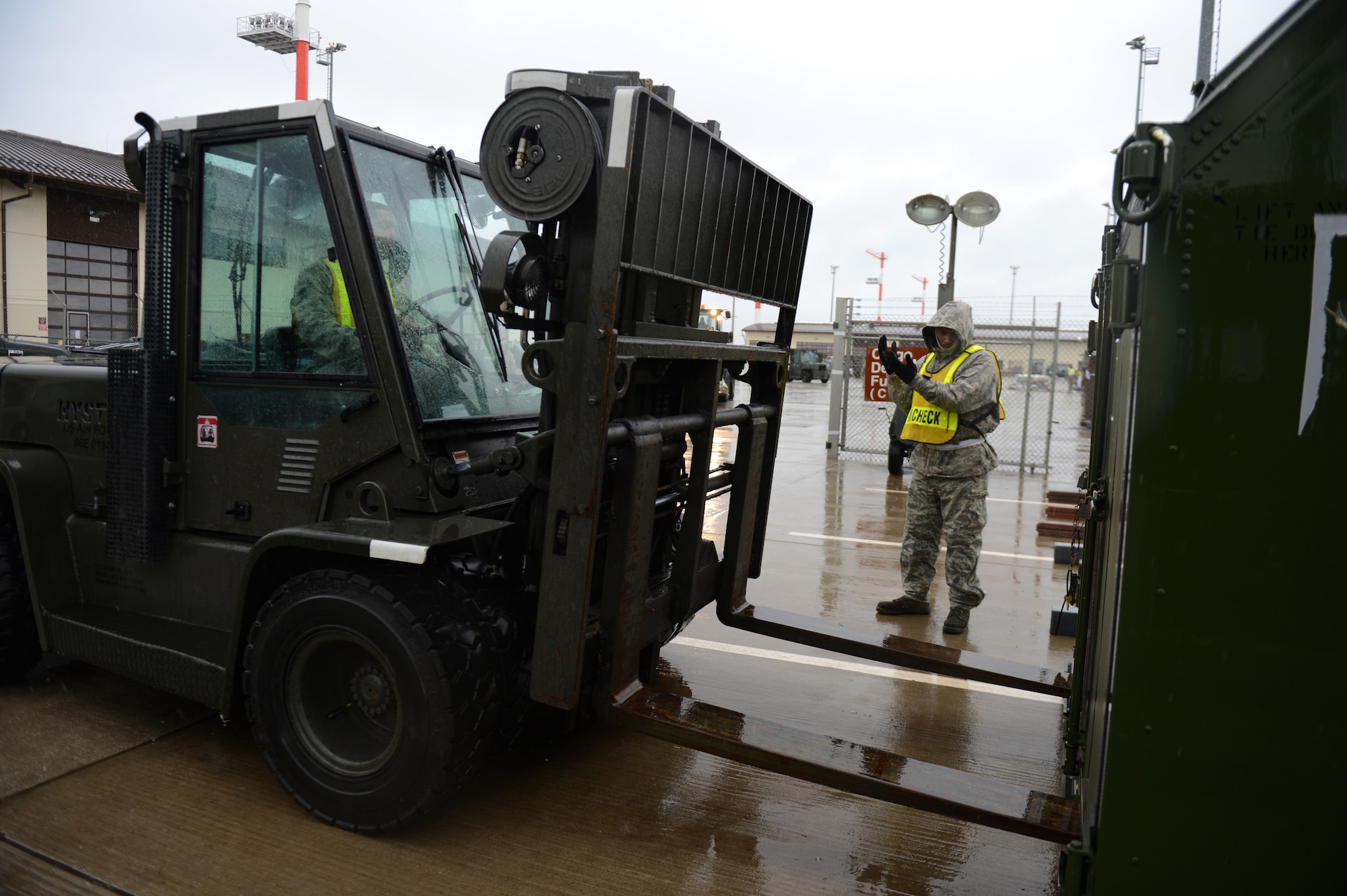 SPANGDAHLEM AIR BASE, Germany – U.S. Air Force Senior Airman Ricky Rivers, 52nd Logistics Readiness Squadron vehicle maintainer from Louvale, Ga., guides a forklift on the flightline Dec. 27, 2012. Airmen will measure and weigh the cargo before it is loaded onto its designated plane. The cargo will accompany the 480th Fighter Squadron to Nellis Air Force Base for Red Flag, an advanced aerial combat training exercise. (U.S. Air Force photo by Airman 1st Class Gustavo Castillo/Released)