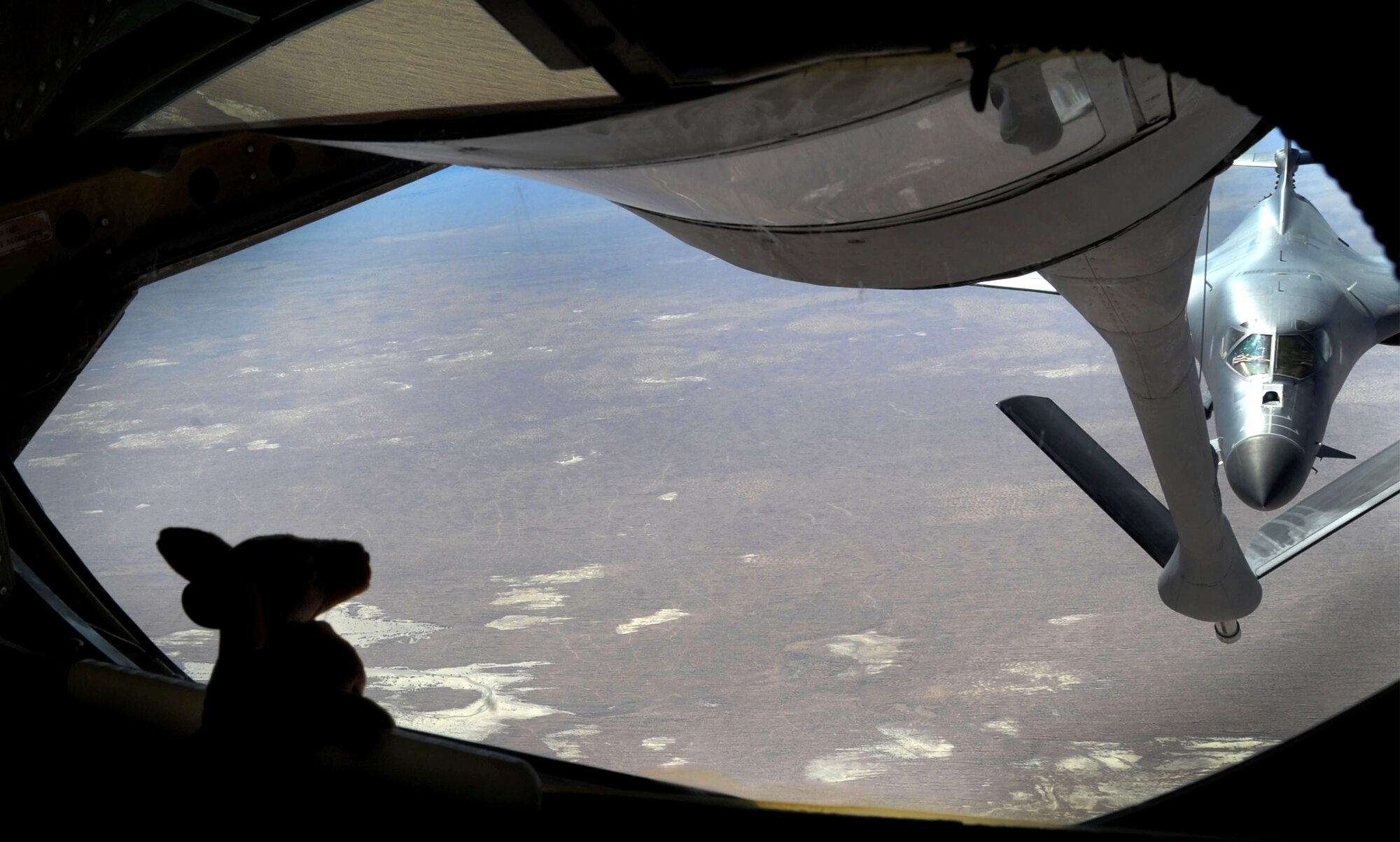 A 340th Expeditionary Air Refueling Squadron KC-135 Stratotanker prepares to refuel a B-1B Lancer over Afghanistan, Dec. 22. The B-1B, deployed from Ellsworth Air Force Base, S.D., flew 26 U.S. flags over Afghanistan for the Sandy Hook Elementary School shooting in Connecticut while conducting missions in support of Operation Enduring Freedom. Capt. Matthew Mills, 340th Expeditionary Air Refueling Squadron pilot, keeps a stuffed animal on board for his niece to show her everywhere he has travelled. Mills is deployed from Pease Air National Guard Base, N.H. and is a native of Clemson, S.C. (US Air Force photo/Staff Sgt. Ashley Reed)