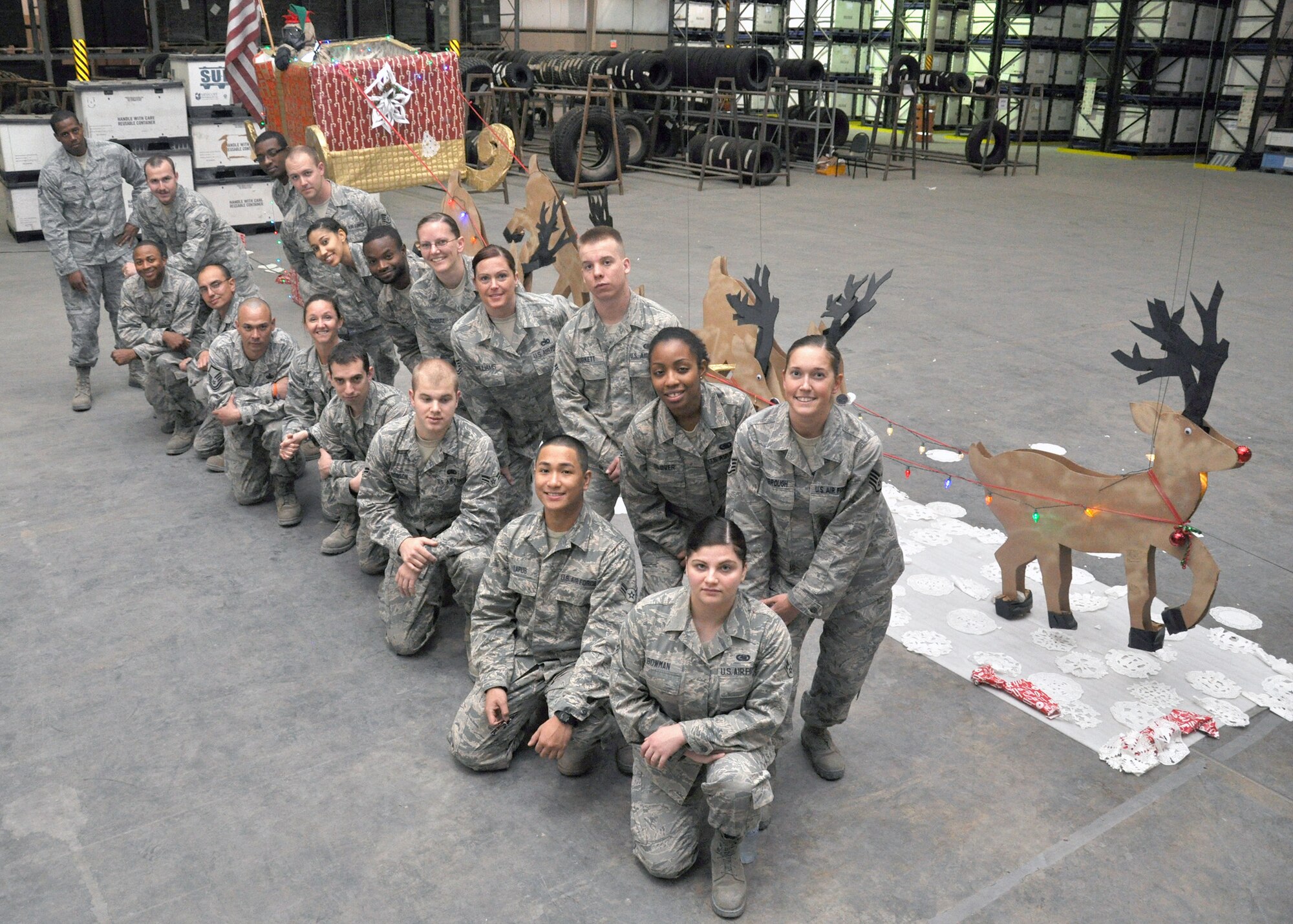 The 379th Expeditionary Logistics Readiness Squadron got creative for Christmas 2012, designing a door display and suspended Santa's sleigh and reindeer as a positive morale booster for the holiday season. The project totaled two weeks of effort by 28 staff using mostly warehouse-available materials and supplies bought in the nearby city and shipped from families back home. "We're all one big family here in the AOR," said Master Sgt. Sorot Boonkian, 379th ELRS Theatre Distribrution Center noncommissioned officer in charge. "You can actually see how much joy and pride these guys put into this." (U.S. Air Force photo/Master Sgt. Christian Michael)