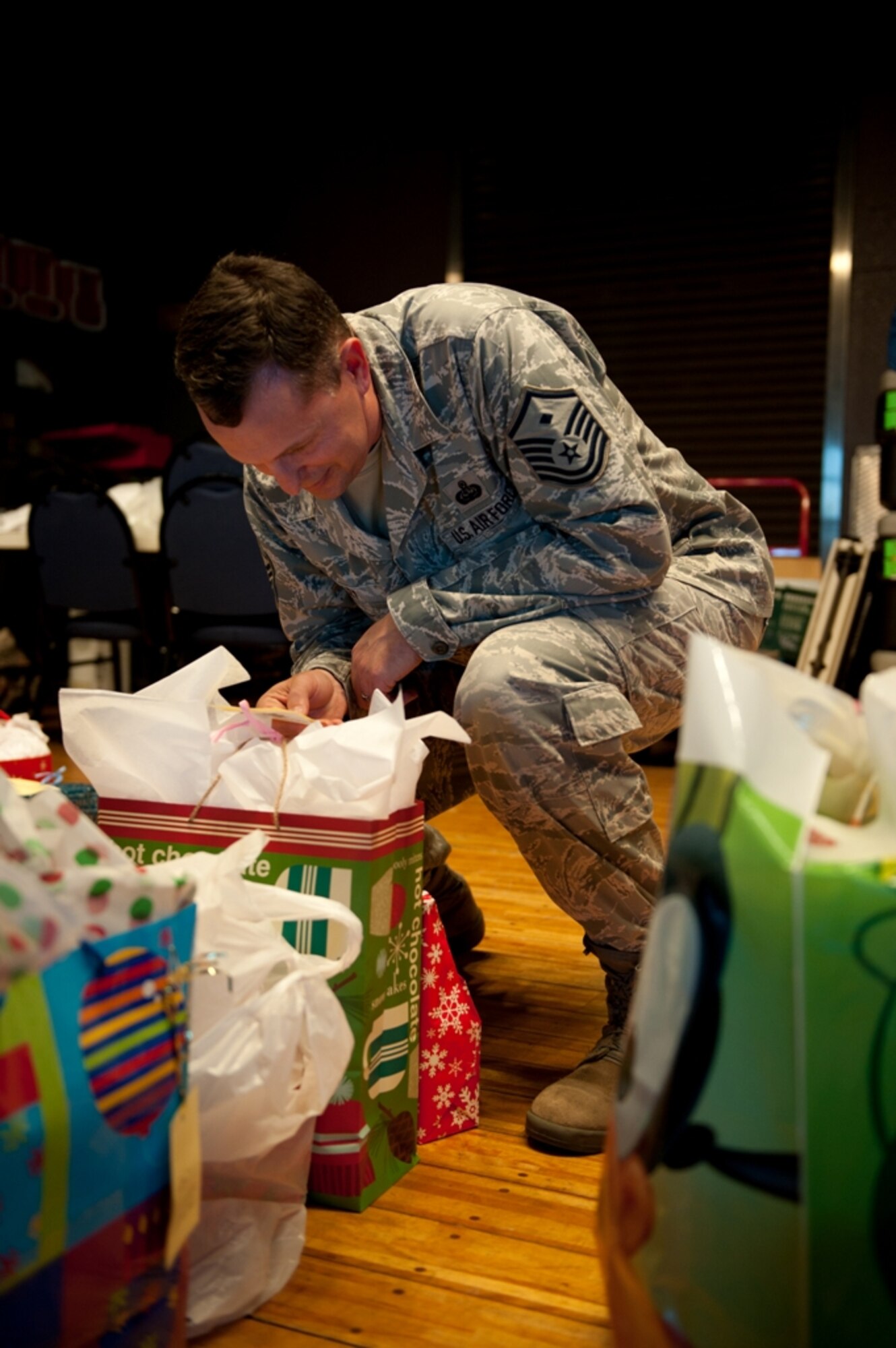 YOKOTA AIR BASE, Japan -- Master Sgt. Mike Worley, 374th Security Forces Squadron first sergeant, reads a tag on a gift for the Angel Tree program, Dec. 19, 2012, at the Airman and Family Readiness Center at Yokota Air Base, Japan. Every year, the First Sergeants' Council coordinates a gift collection for deserving children in the Yokota community. (U.S. Air Force photo by Airman 1st Class Desiree Economides)