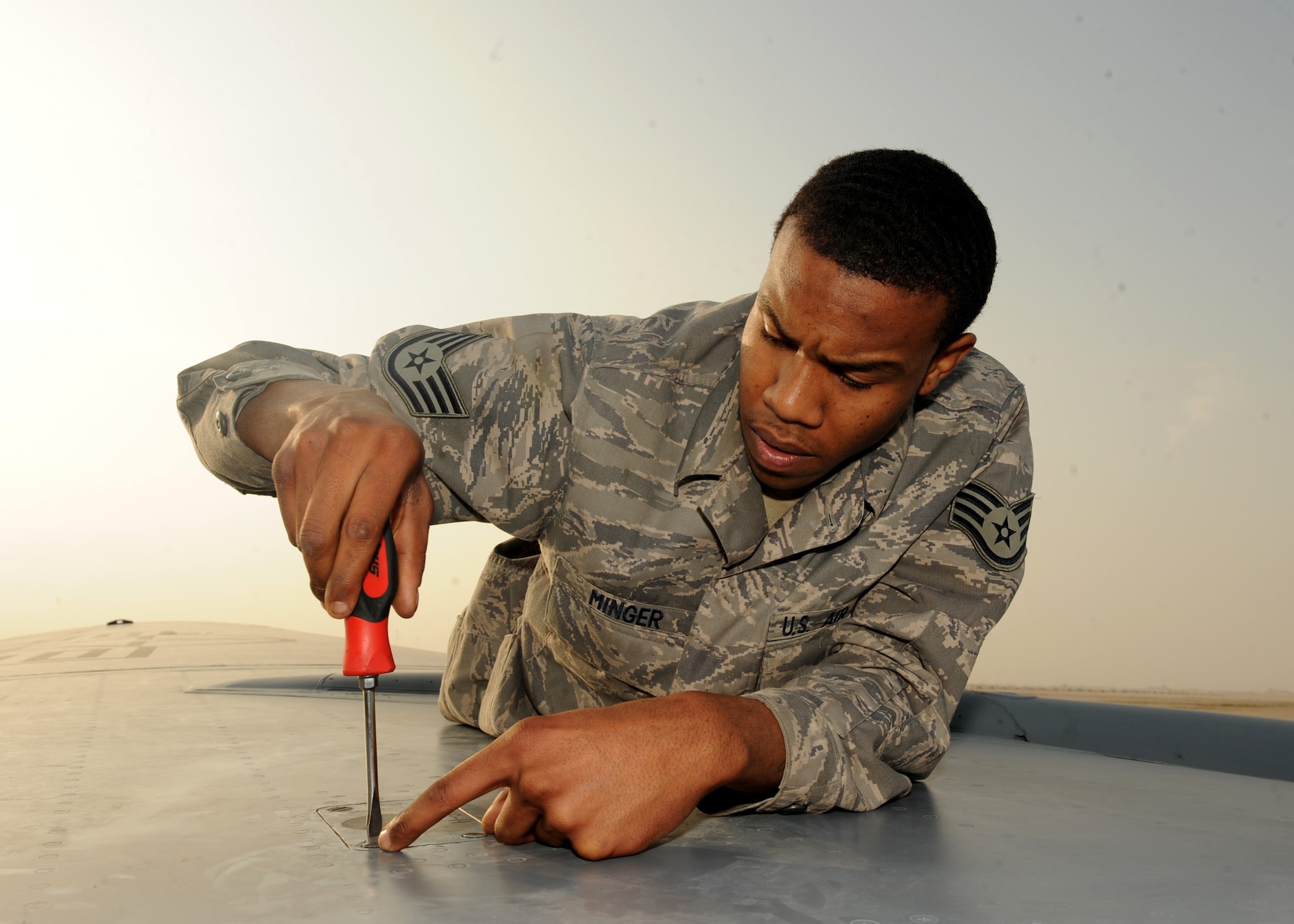 SOUTHWEST ASIA – Staff Sgt. Jerrod Minger, 379th Expeditionary Maintenance Squadron fuel systems craftsman, replaces a cover protecting fuel lines after relieving the hydraulic pressure on top of the left wing of a KC-135 Dec. 26. Minger is deployed from the 108th Air National Guard Maintenance Squadron at McGuire Air Force Base, N.J., and is a native of Columbia, S.C. (U.S. Air Force photo/Senior Airman Joel Mease)