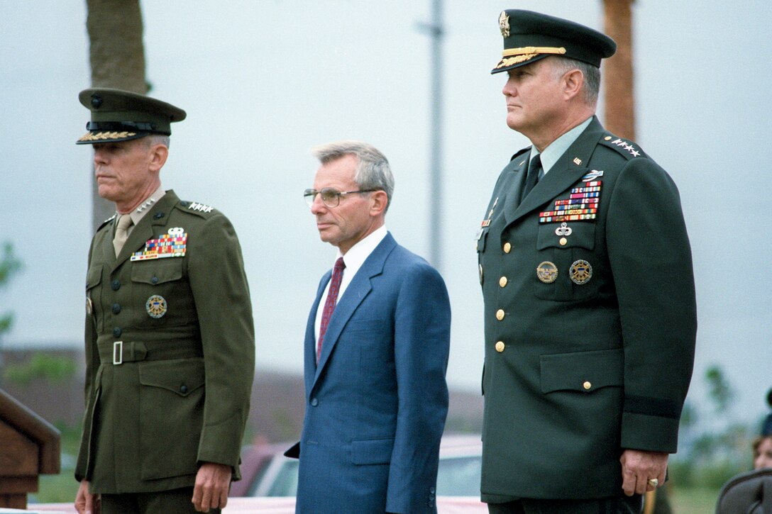 Defense Secretary Frank C. Carlucci, center, transfers the reins of command of U.S. Central Command from U.S. Marine Corps Gen. George B. Crist, left, to Army Gen. H. Norman Schwarzkopf, Nov. 1, 1988. Schwarzkopf was a Vietnam veteran and one of the architects of the western flanking movement that helped to defeat the Iraqi army during the Gulf War in early 1991. As commander of U.S. Centcom, he led the international coalition assembled by then-President George H.W. Bush that expelled Iraqi troops who had invaded Kuwait in August 1990.