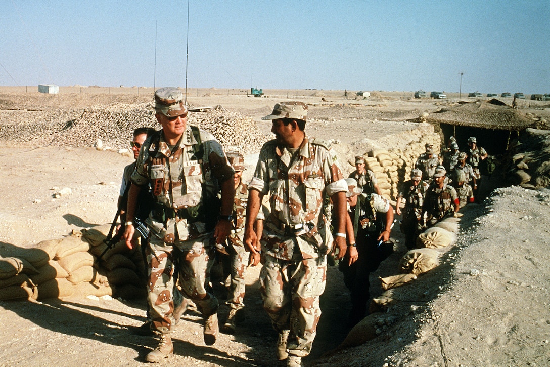 U.S. Army Gen. H. Norman Schwarzkopf, commander of U.S. Central Command,  emerges from a camouflaged trench in the desert while visiting with troops from other countries during Operation Desert Shield, April 1, 1992. 