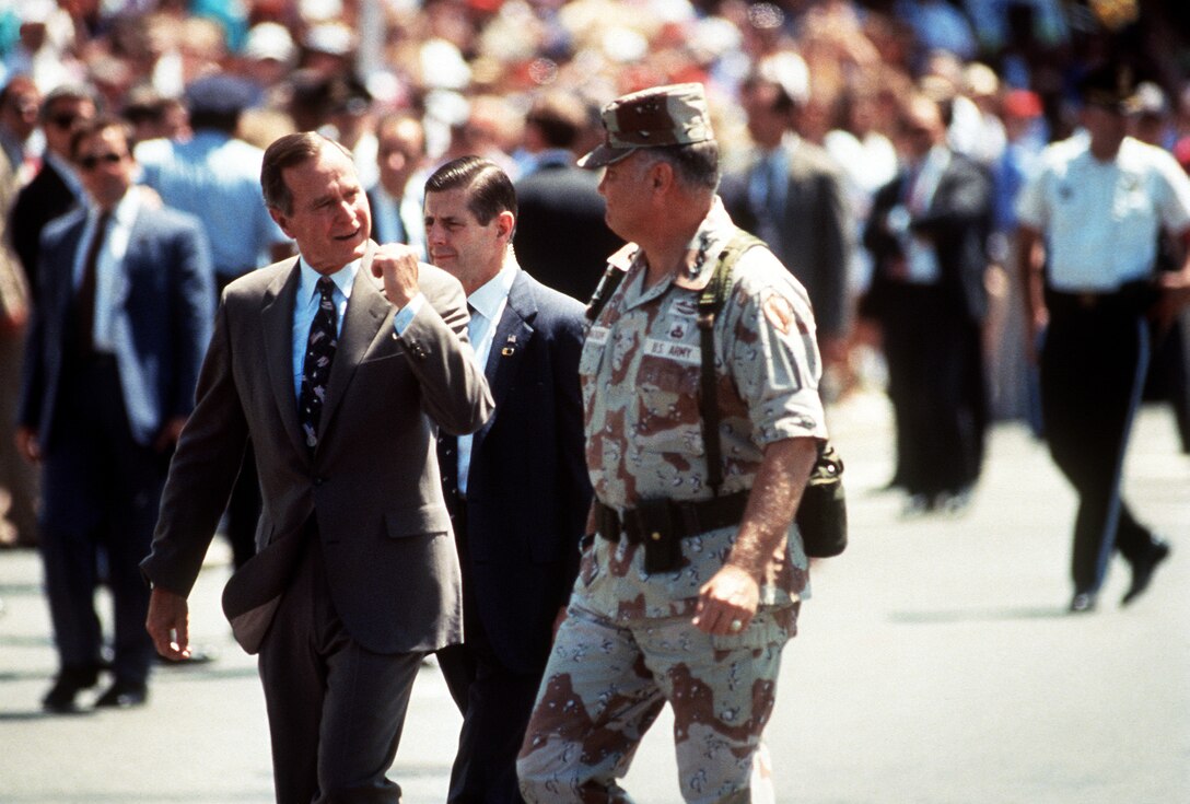 President George H.W. Bush, left, and Army Gen. H. Norman Schwarzkopf, commander of U.S. Central Command, walk to the reviewing stand at the beginning of the National Victory Celebration parade, June 8, 1991.  The day-long celebration was being held in honor of the coalition forces that liberated Kuwait during Operation Desert Storm. 