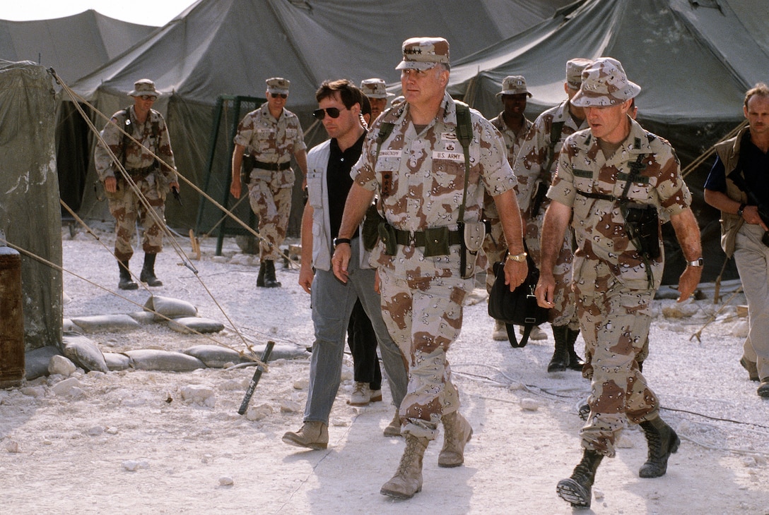 U.S. Army Gen. H. Norman Schwarzkopf, commander of U.S. Central Command, talks with U.S. Army Maj. Gen. Barry McCaffrey, commanding general, 24th Infantry Division (Mechanized), while at the tent city of the 18th  Airborne Corps, Jan. 1, 1992. Schwarzkopf is visiting Allied units that took part in Operation Desert Storm.