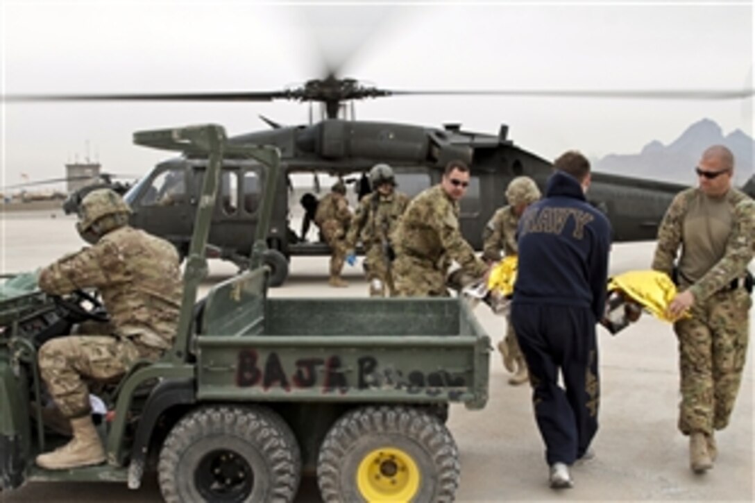 Provincial Reconstruction Team Farah medics and medical evacuation personnel assigned to the U.S. Army's Company C, 2nd Battalion, 211th Aviation Regiment, transfer an Afghan man from a medevac helicopter to a vehicle on Forward Operating Base Farah, Afghanistan, Dec. 26, 2012. The team's mission is to train, advise and assist Afghan government leaders at the municipal, district and provincial levels in Farah province. 