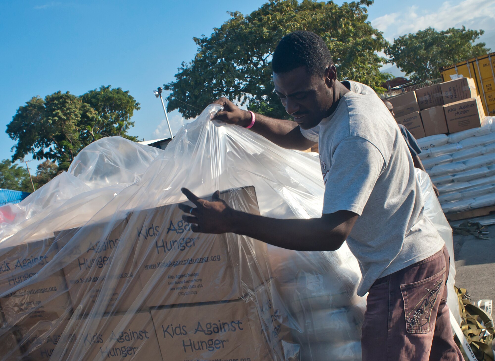 PORT-AU-PRINCE, HAITI – A Haitian citizen unpacks a pallet of food in Port Au Prince, Haiti, Dec. 28, 2012. The food that was transported by members of the 58th Airlift Squadron members weighed 137,000 pounds and was the largest single-day humanitarian aid shipment since 1998. The goods were donated by Operation Ukraine, a nonprofit organization that provides relief to Haitian citizens with food, medicine, and school supplies. (U.S. Air Force photo by Airman 1st Class Levin Boland / Released)
