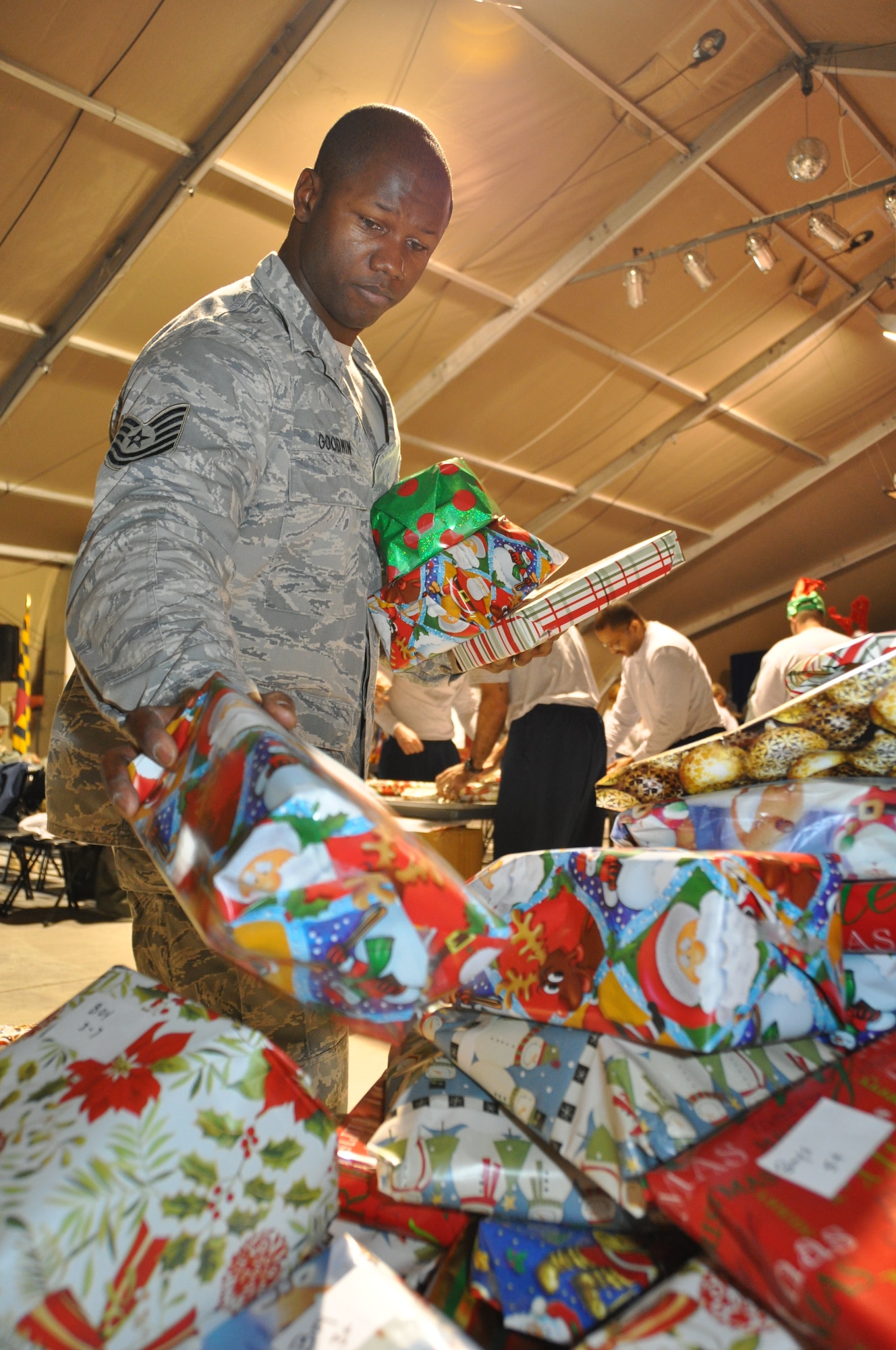 Tech. Sgt. Lamount Goodwin, 376th Expeditionary Security Forces Squadron flight chief, sorts wrapped toys during a toy wrapping party at the Transit Center at Manas, Kyrgyzstan, Dec. 23, 2012. Goodwin was one of the organizers of a Transit Center holiday toy drive to benefit local orphanages. (U.S. Air Force photo/Tech. Sgt. Rachel Martinez)