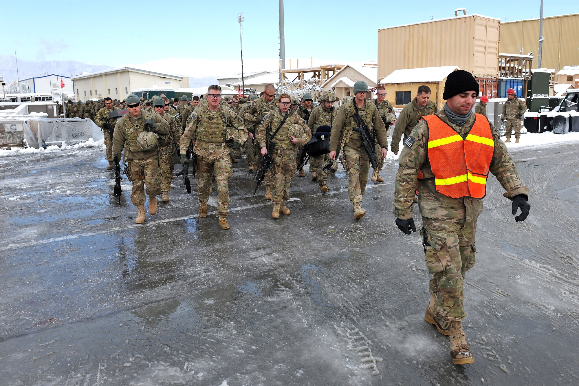 BAGRAM AIRFIELD, Afghanistan – Senior Airman Darren Arsenault, 455th Expeditionary Aerial Port Squadron passenger services agent, walks servicemembers out from the terminal to the flightline here, Dec. 28, 2012.  The 455th EAPS moves the highest number of passengers in the Department of Defense, with 1,200 passing through its doors on an average day. (U.S. Air Force photo/Senior Airman Chris Willis)