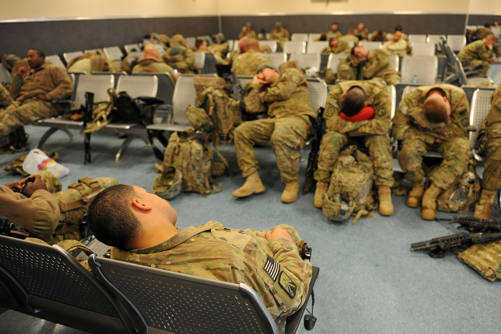 BAGRAM AIRFIELD, Afghanistan --Servicemembers wait at the 455th Expeditionary Aerial Port Squadron passenger terminal for an outgoing flight here, Dec. 28, 2012.  The 455th EAPS moves the highest number of passengers in the Department of Defense, with 1,200 passing through its doors on an average day. (U.S. Air Force photo/Senior Airman Chris Willis)