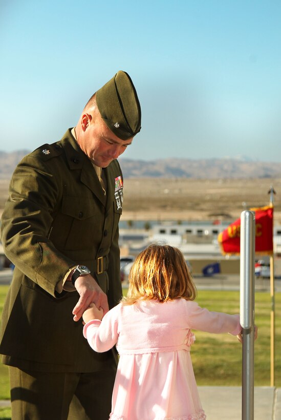 Lt. Col. Matt Good helps his daughter, Ann, down the stairs Dec. 19, 2012, at Lance Cpl. Torrey L. Gray Field.