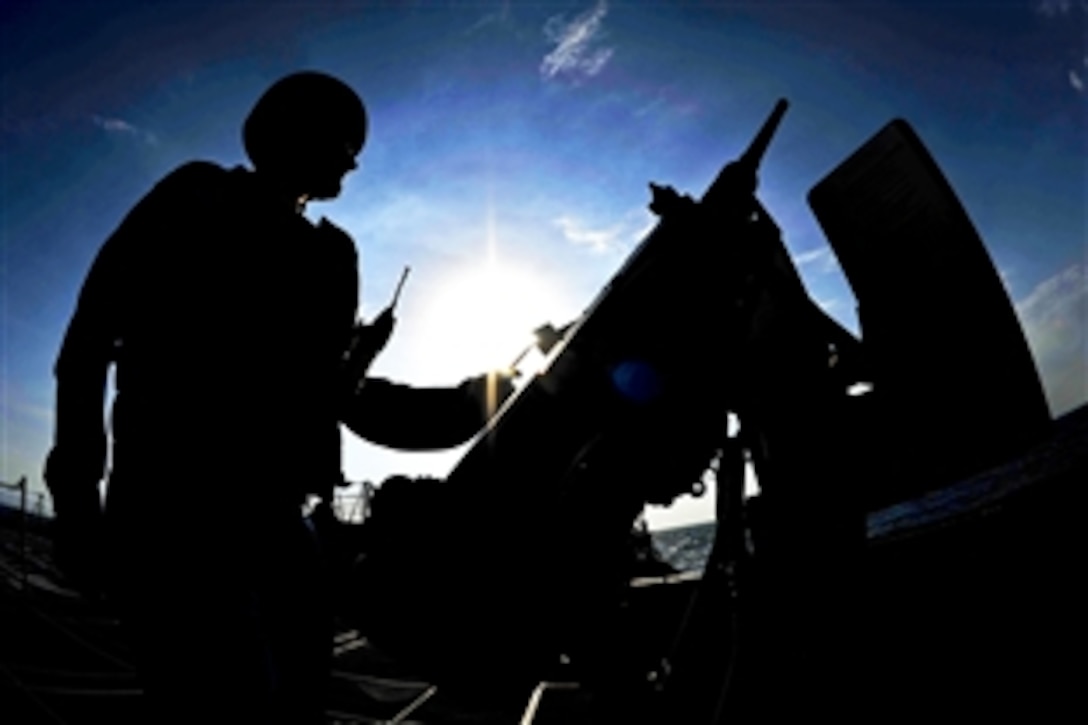 U.S. Navy Petty Officer 3rd Class Travis Hetrick mans an M2HB .50-caliber machine gun aboard the guided missile destroyer the USS Jason Dunham while under way in the U.S. 5th Fleet area of responsibility, Dec. 27, 2012. The Dunham, part of the John C. Stennis Carrier Strike Group, was deployed to conduct maritime security operations and theater security cooperation efforts to support Operation Enduring Freedom. 