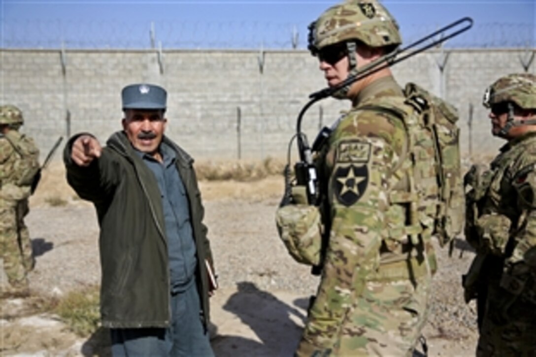 Abdul Qayoom, left, Farah City prison commander, points out the prison's sewer area to U.S. Army Sgt. William Russell, center, security force team member for Provincial Reconstruction Team Farah, and U.S. Army Lt. Col. Mark Martin, right, during a meeting with key leaders at the prison in Farah City, Afghanistan, Dec. 29, 2012. The team's mission is to train, advise and assist Afghan government leaders at the municipal, district and provincial levels in the province.
