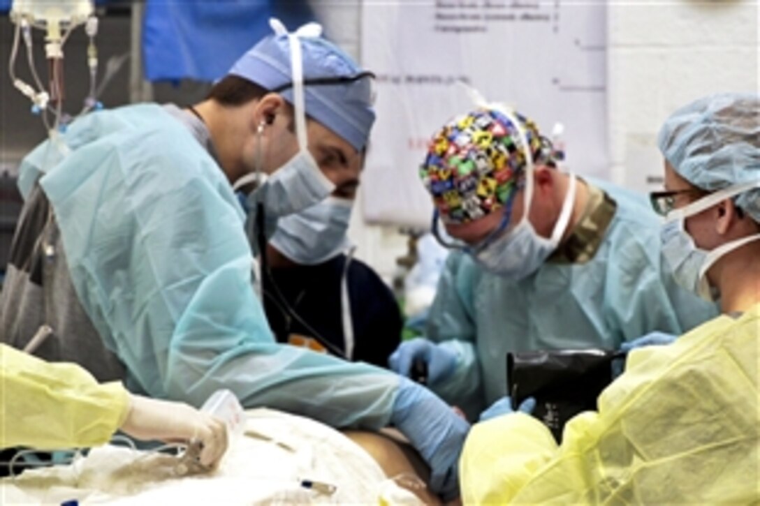 Medical personnel assess an Afghan man on Forward Operating Base Farah, Afghanistan, Dec. 26, 2012. The soldiers are assigned to the 541st Forward Surgical Team.