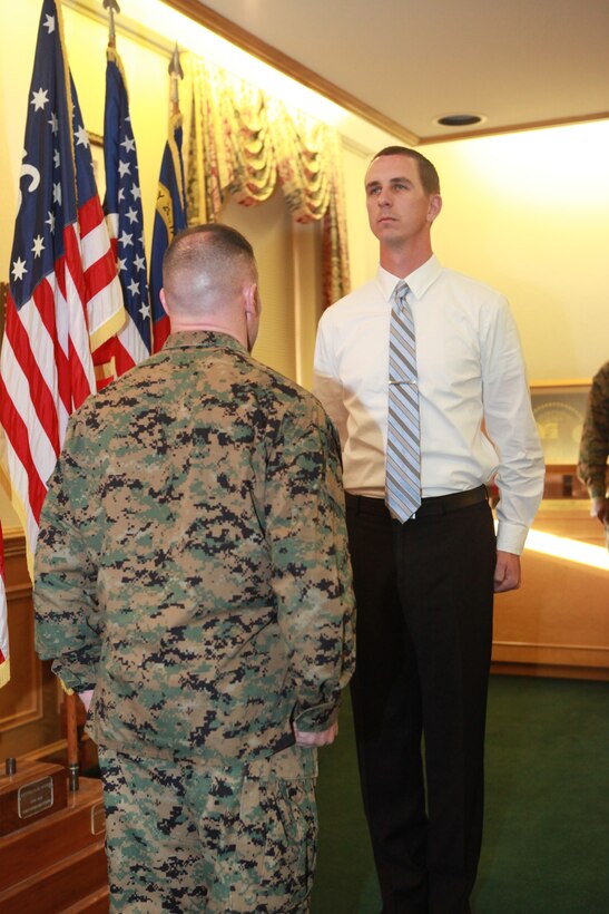 Col. Daniel J. Lecce, commanding officer of Marine Corps Base Camp Lejeune awarded David L. Swinney, an administrative support specialist with S-4, Headquarters and Support Battalion, Marine Corps Base Camp Lejeune, with the Meritorious Civilian Service Award during the ceremony held in building 1 aboard MCB Camp Lejeune, Feb. 1. Swinney competed with nearly 4,000 civilian employees to earn the award.