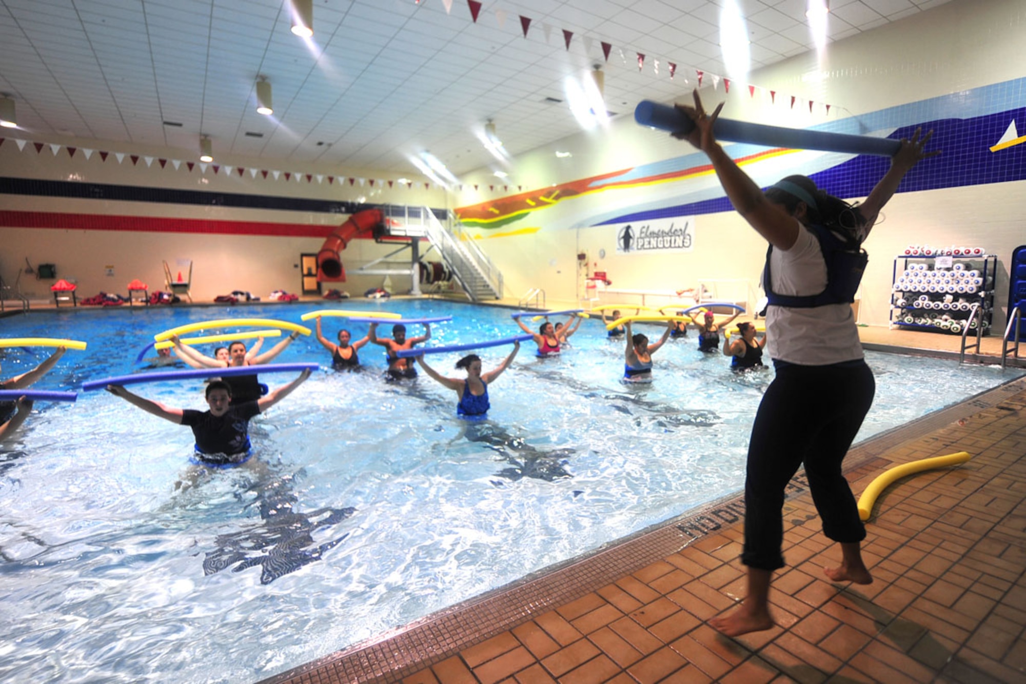 Gloria Bechtol, water aerobics instructor, demonstrates a highkick using a pool noodle at the Elmendorf Fitness Center on Joint Base Elmendorf-Richardson. With two full fitness centers and other smaller facilities like Hangar 5 on the installation, there’s
a fitness niche for everyone. Water aerobics, inner-tube water polo and water jogging are popular, as are classes like Zumba, spinning and yoga. (U.S. Air Force photo/Staff Sgt. Sheila deVera)