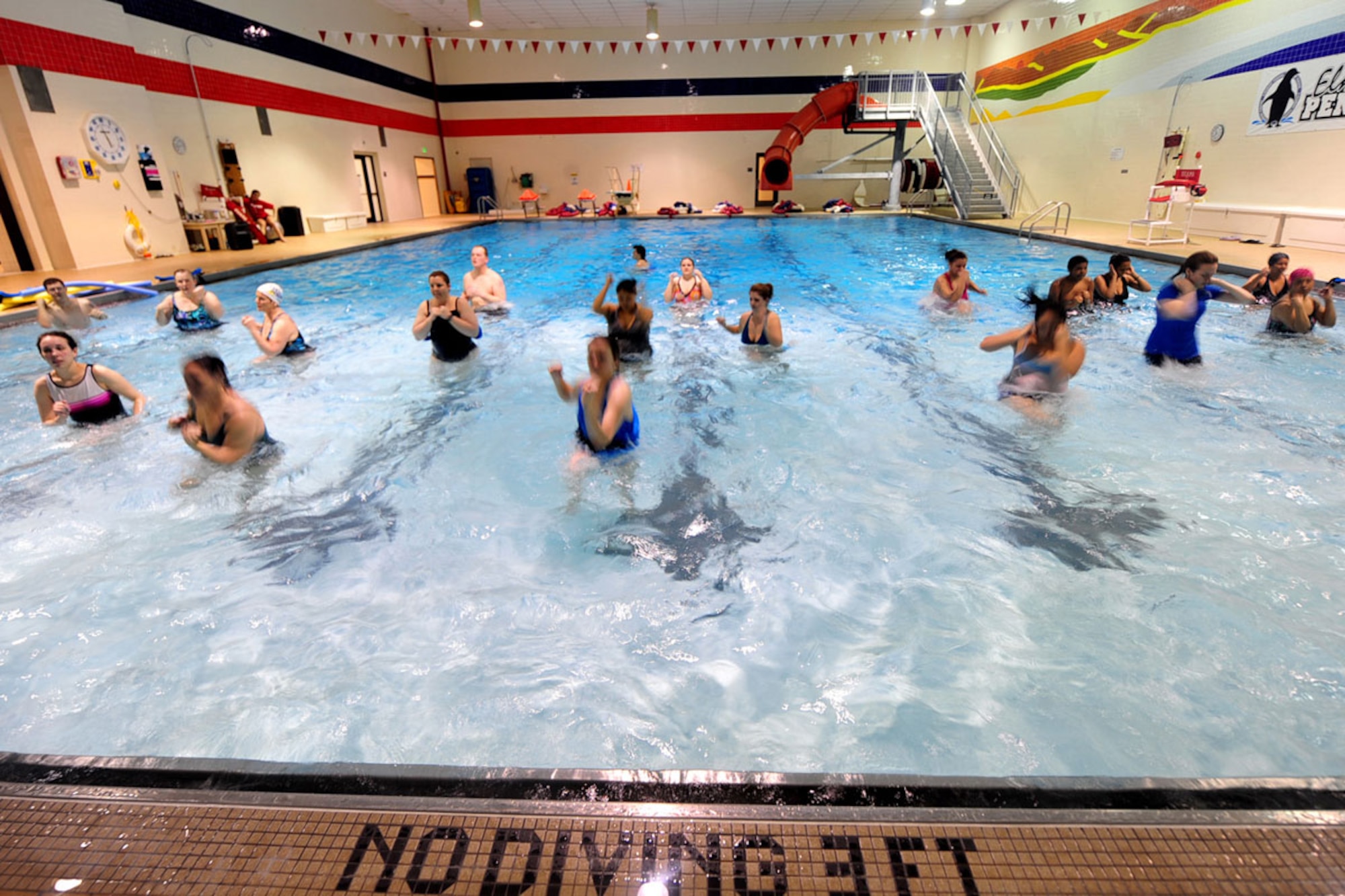 Water aerobics students demonstrate a knee cross at the Elmendorf Fitness Center on Joint Base Elmendorf-Richardson Monday. Water aerobic class offers a low-impact,
high-movement workout for cardiovascular, upper and lower body strength and resistance training. (U.S. Air Force photo/Staff Sgt. Sheila deVera)