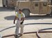 Senior Airmen Darius Dobbs, a 940th Civil Engineer Squadron fire fighter deployed to Southwest Asia, works under the hot desert sun to lay out fire hoses.  Dobbs is one of a group of 940th Wing Reservists currently on an extended deployment with the 405th Expeditionary Civil Engineer Squadron. (Courtesy photo)